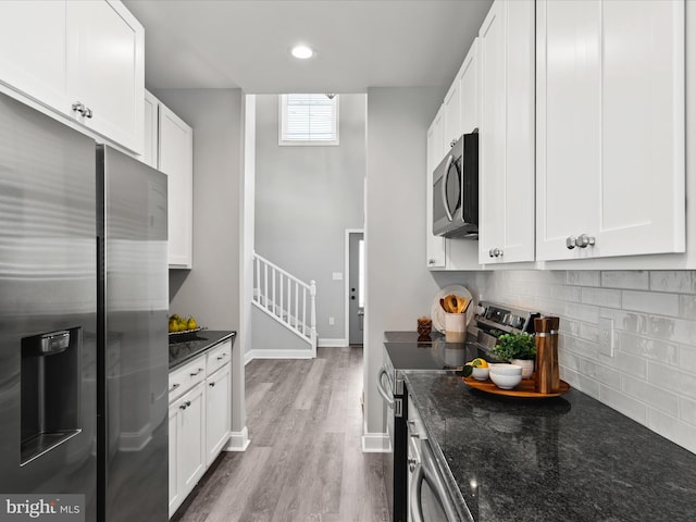 36986 Blue Teal Rd, Selbyville, DE 19975 - kitchen featuring backsplash, stainless steel appliances, white cabinetry, and wood finished floors