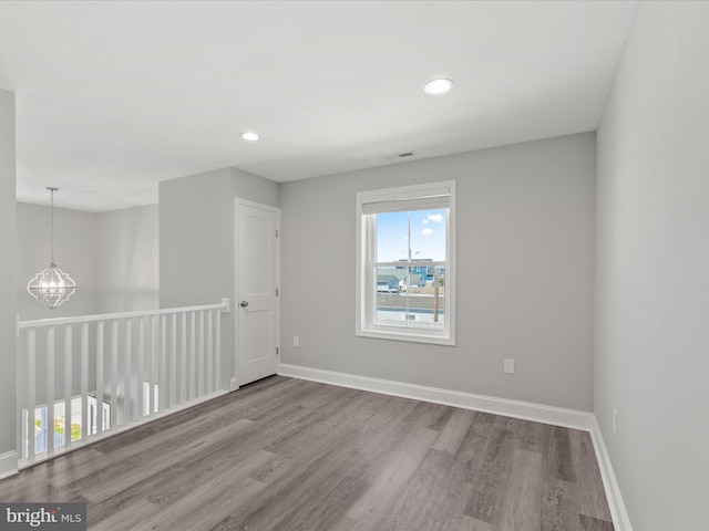 36986 Blue Teal Rd, Selbyville, DE 19975 - empty room with baseboards, recessed lighting, wood finished floors, and a notable chandelier