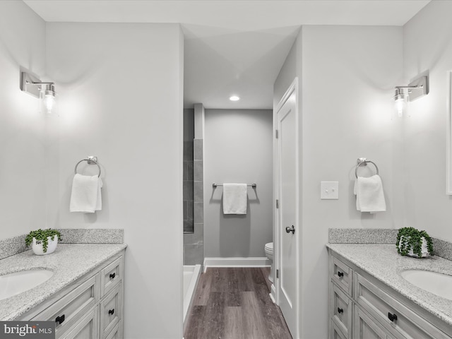 36986 Blue Teal Rd, Selbyville, DE 19975 - full bathroom with wood finished floors, a sink, two vanities, and toilet