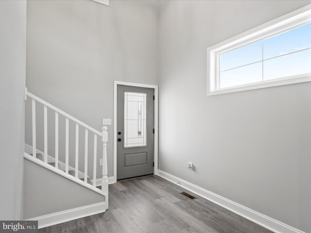 36986 Blue Teal Rd, Selbyville, DE 19975 - foyer entrance with baseboards, wood finished floors, visible vents, and stairway