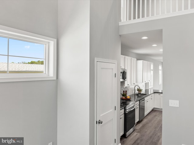 36986 Blue Teal Rd, Selbyville, DE 19975 - kitchen with white cabinets, dark countertops, appliances with stainless steel finishes, and a sink