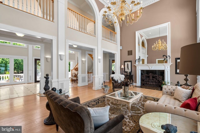 285 Eagle Hill Rd, Pasadena, MD 21122 - living room featuring wood finished floors, crown molding, a high ceiling, and a chandelier