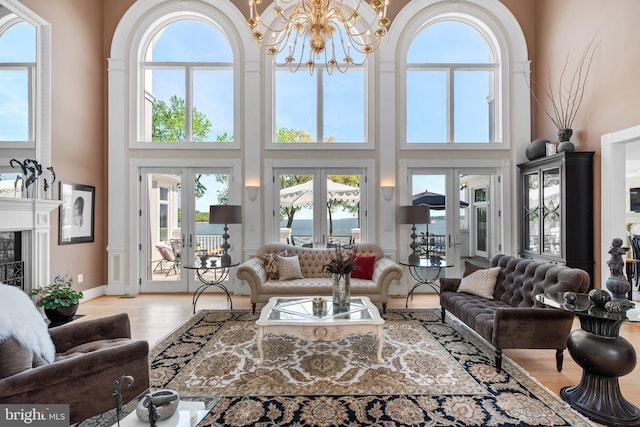 285 Eagle Hill Rd, Pasadena, MD 21122 - living area featuring an inviting chandelier, a high ceiling, french doors, and a healthy amount of sunlight