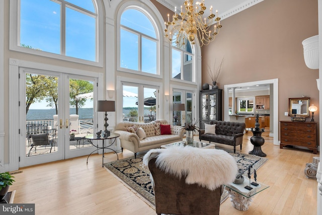 285 Eagle Hill Rd, Pasadena, MD 21122 - living room featuring a water view, a high ceiling, french doors, and light wood-type flooring