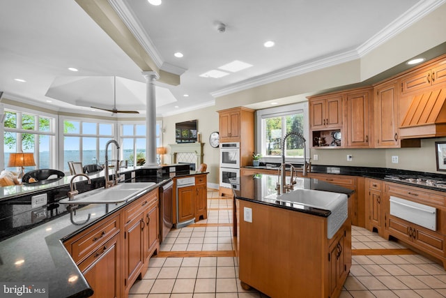 285 Eagle Hill Rd, Pasadena, MD 21122 - kitchen featuring a sink, a center island with sink, ornate columns, ornamental molding, and a warming drawer