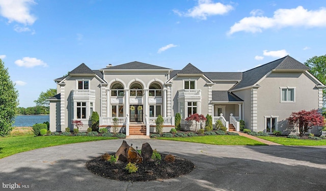 285 Eagle Hill Rd, Pasadena, MD 21122 - view of front of home with curved driveway, a porch, and a balcony