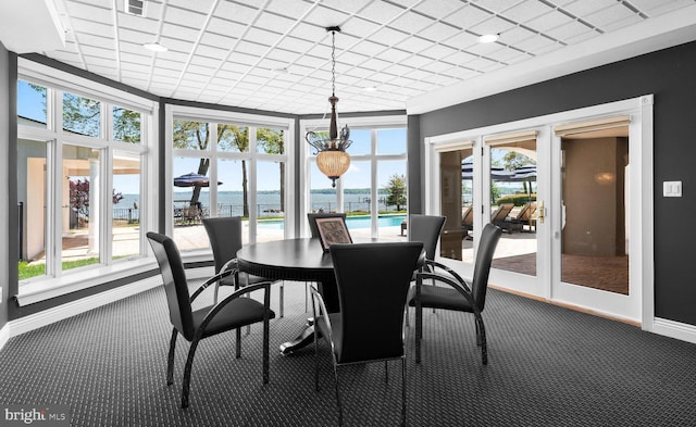 285 Eagle Hill Rd, Pasadena, MD 21122 - dining area featuring baseboards, a water view, carpet flooring, and a wealth of natural light