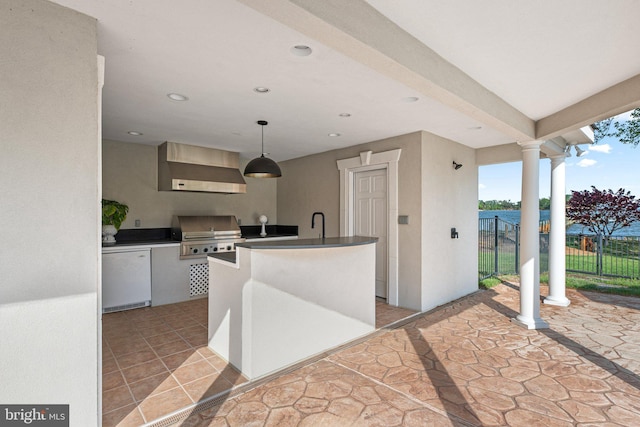 285 Eagle Hill Rd, Pasadena, MD 21122 - kitchen with a center island with sink, refrigerator, ornate columns, recessed lighting, and wall chimney exhaust hood