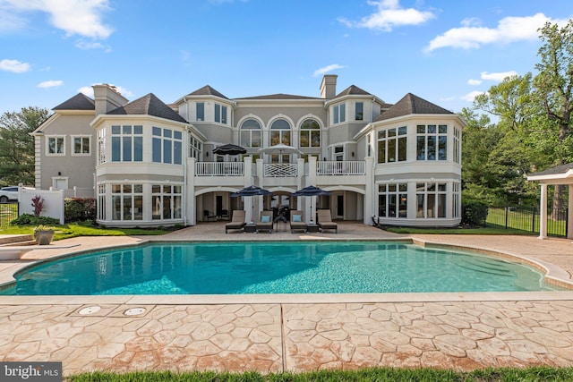 285 Eagle Hill Rd, Pasadena, MD 21122 - rear view of house with a fenced in pool, fence, a patio area, and a balcony