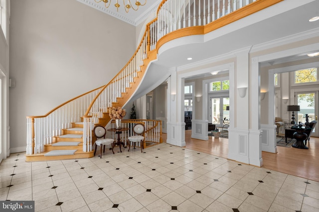 285 Eagle Hill Rd, Pasadena, MD 21122 - tiled entryway featuring decorative columns, a high ceiling, a healthy amount of sunlight, and stairway