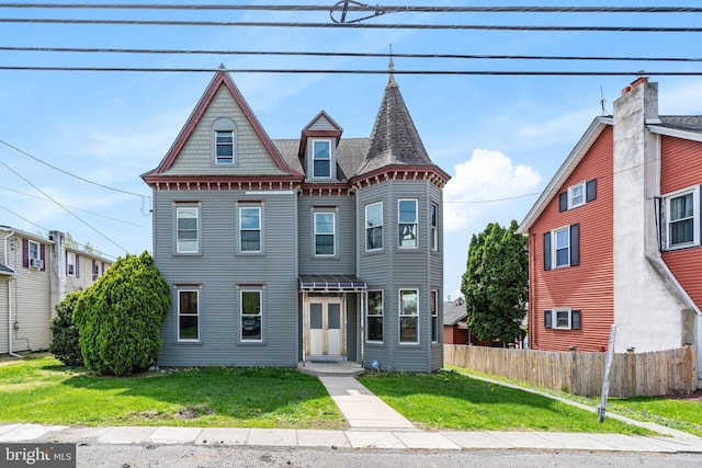 7818 Main St, Fogelsville, PA 18051 - victorian home featuring roof with shingles, fence, and a front yard