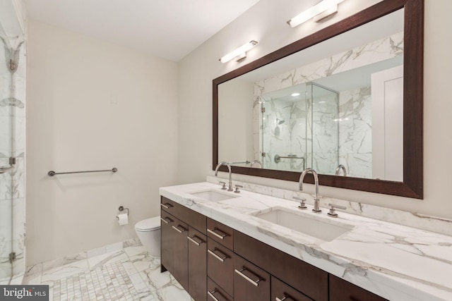 bathroom with a sink, a marble finish shower, toilet, and marble finish floor