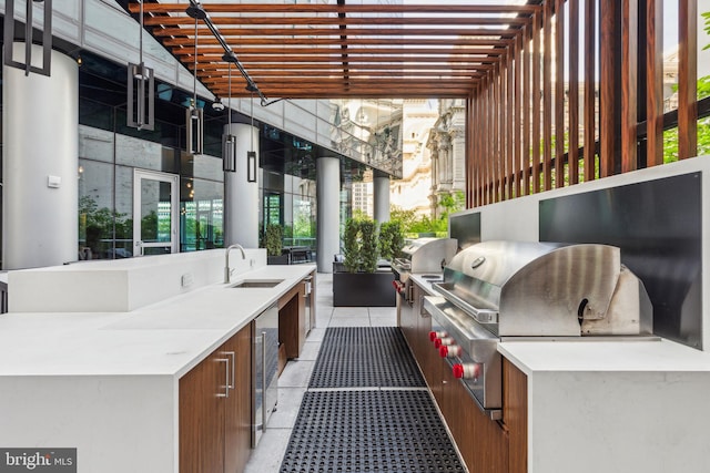 view of patio featuring grilling area, a sink, and an outdoor kitchen