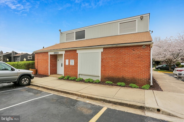 18478 Stone Holw, Germantown, MD 20874 - view of property with uncovered parking, a shingled roof, and brick siding