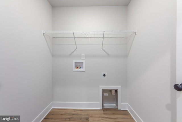 clothes washing area with laundry area, wood finished floors, baseboards, washer hookup, and hookup for an electric dryer