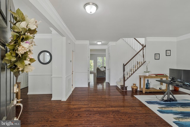 entryway featuring ornamental molding, stairs, and wood finished floors