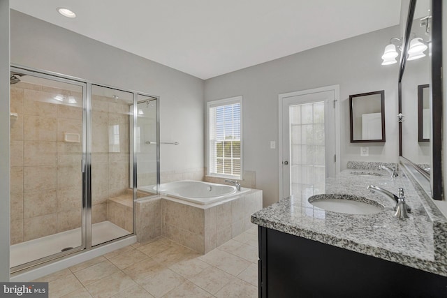 bathroom with tile patterned flooring, a sink, a bath, and a stall shower