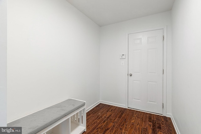 mudroom featuring baseboards and dark wood-style flooring