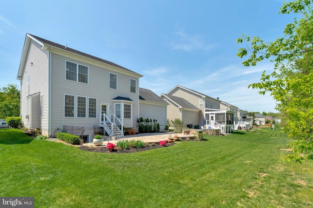 rear view of property with a lawn, a residential view, and a patio area