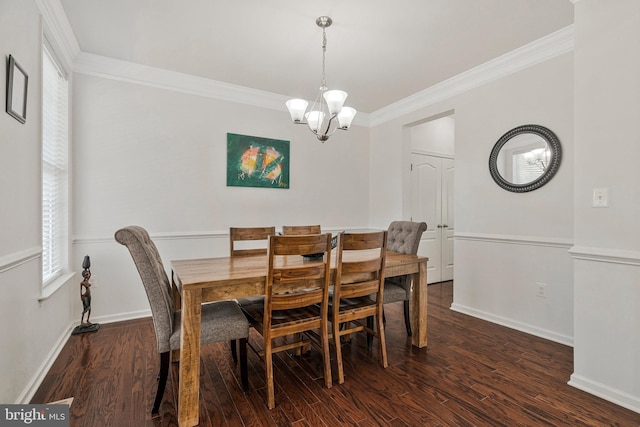 dining room with crown molding, baseboards, a notable chandelier, and wood finished floors