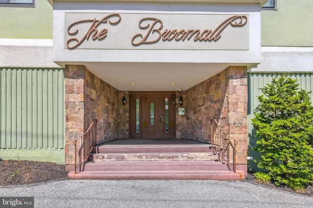 property entrance with stone siding