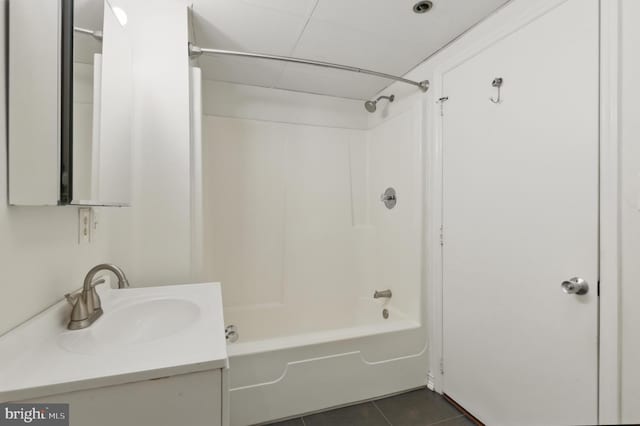 bathroom with tile patterned floors,  shower combination, and vanity