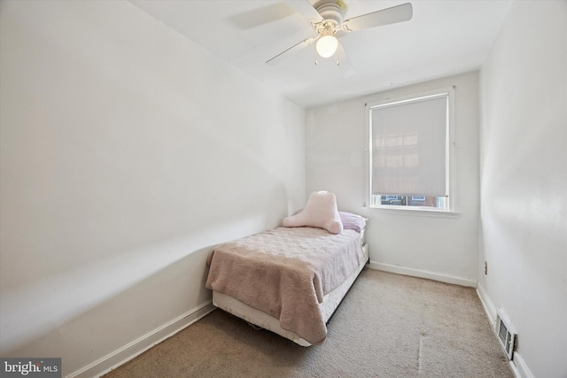 carpeted bedroom with a ceiling fan, baseboards, and visible vents