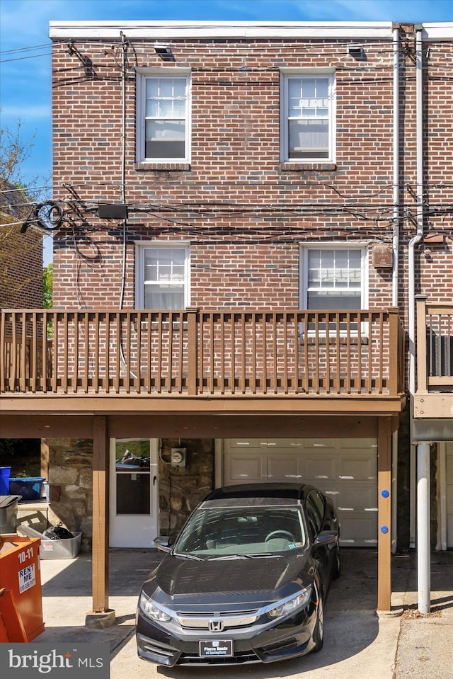 exterior space featuring an attached garage and brick siding