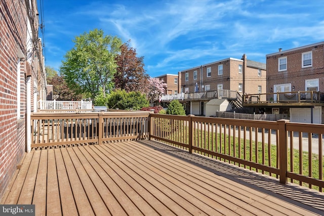 wooden terrace with a fenced backyard and a residential view