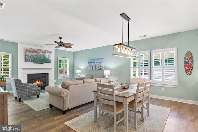 dining space featuring plenty of natural light, visible vents, wood finished floors, and a ceiling fan