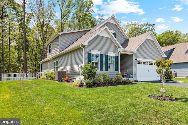 view of front of house with aphalt driveway, fence, central AC, a garage, and a shingled roof