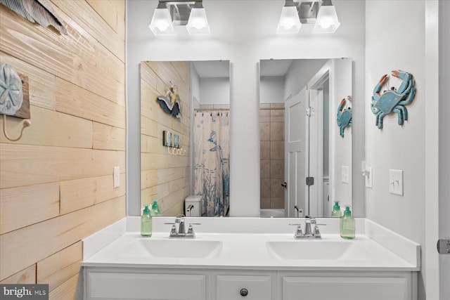 full bath with double vanity, toilet, a shower with curtain, a sink, and wooden walls