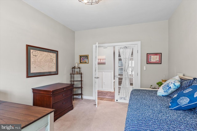 bedroom with light carpet and baseboards