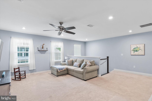 carpeted living area with ceiling fan, baseboards, visible vents, and recessed lighting