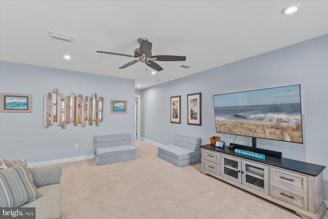 living area featuring light carpet, a ceiling fan, visible vents, and recessed lighting