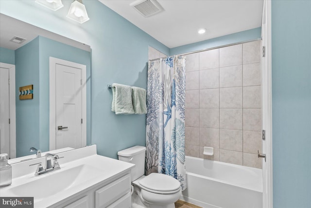 bathroom featuring vanity, toilet, shower / bathtub combination with curtain, and visible vents