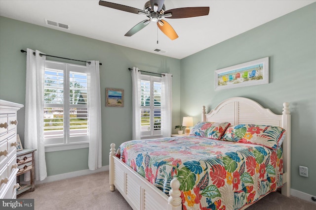 bedroom featuring visible vents, baseboards, and light carpet