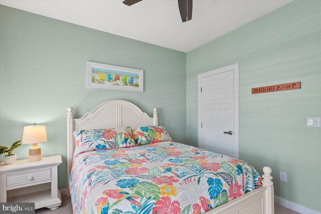 carpeted bedroom featuring ceiling fan and baseboards