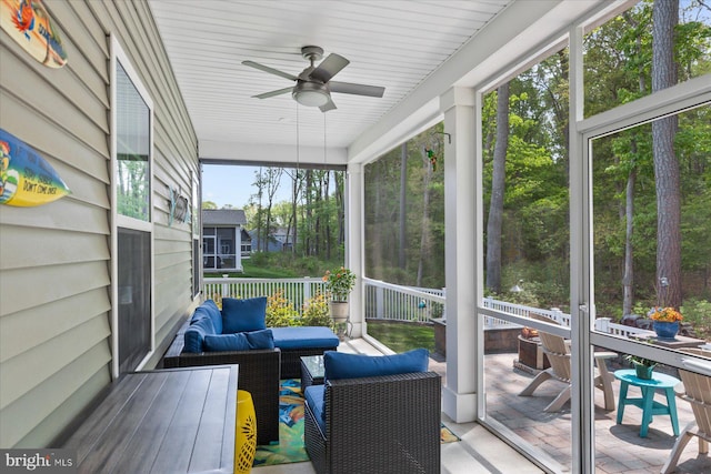 sunroom / solarium with a ceiling fan and outdoor lounge area