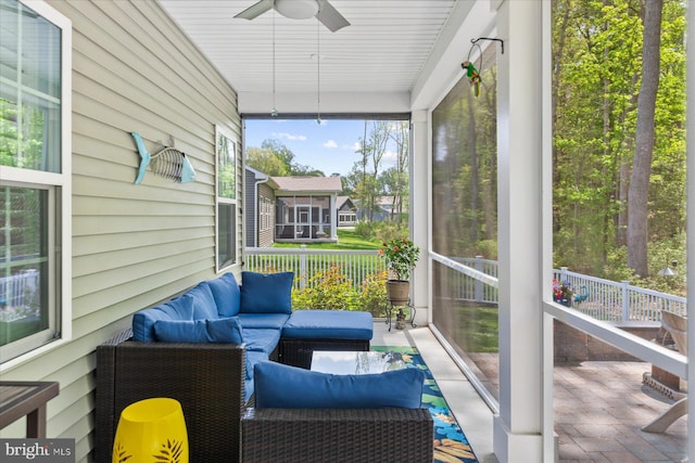 sunroom / solarium with a ceiling fan and an outdoor hangout area