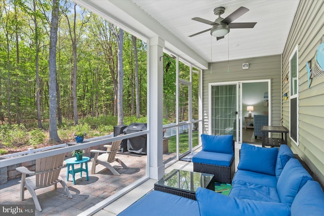 sunroom with a ceiling fan and outdoor lounge area