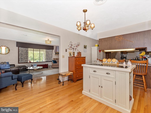 11615 Taneytown Pike, Emmitsburg, MD 21727 - kitchen featuring pendant lighting, light wood-style floors, open floor plan, white cabinets, and a chandelier