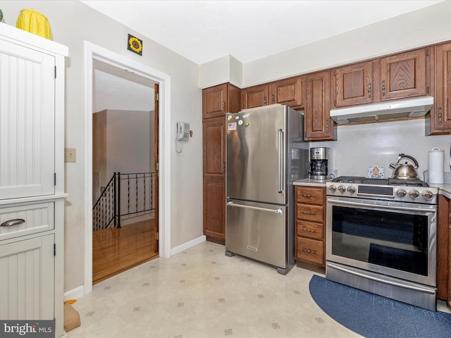 11615 Taneytown Pike, Emmitsburg, MD 21727 - kitchen featuring baseboards, light floors, under cabinet range hood, brown cabinets, and appliances with stainless steel finishes