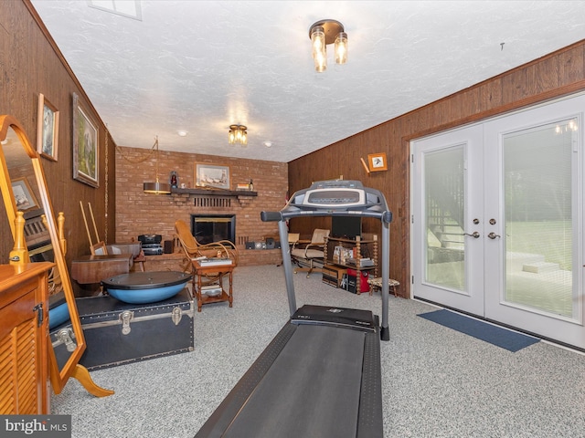 11615 Taneytown Pike, Emmitsburg, MD 21727 - workout room with french doors, a textured ceiling, wooden walls, and a fireplace
