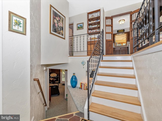11615 Taneytown Pike, Emmitsburg, MD 21727 - stairs featuring carpet floors, a textured wall, and a towering ceiling