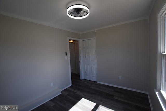 26 Southampton Dr, Willingboro, NJ 08046 - unfurnished bedroom with dark wood-style flooring, baseboards, crown molding, and a closet