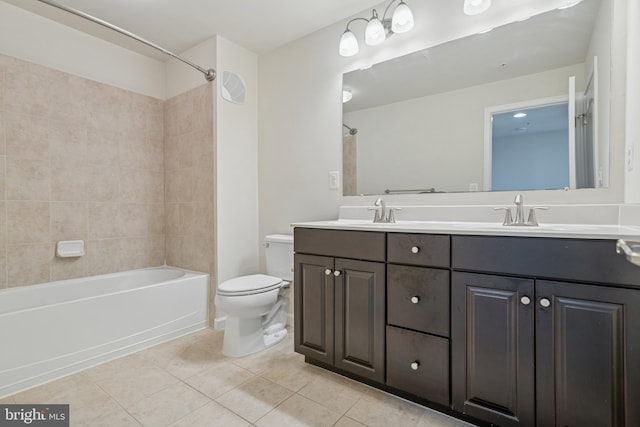 full bath with double vanity, toilet, tile patterned floors, and a sink