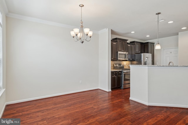 kitchen featuring a notable chandelier, dark wood finished floors, stainless steel appliances, recessed lighting, and tasteful backsplash