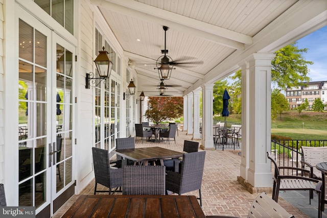 view of patio / terrace with french doors, a ceiling fan, and outdoor dining area