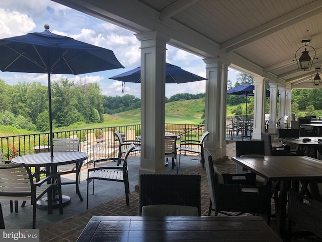 view of patio featuring a ceiling fan and outdoor dining area